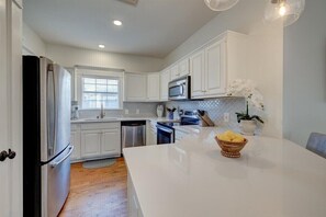 Kitchen with island, window, and potted plant.