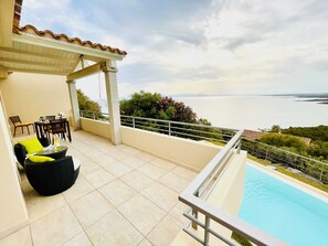 Relax on the serene outdoor terrace, surrounded by a tranquil pool and breathtaking sea views.