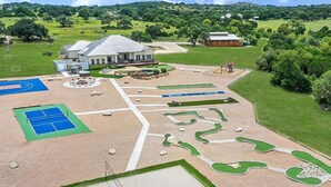 A large property with a main house, tennis courts, a swimming pool, and landscaped gardens. - ** NEW 5 STAR HILL COUNTRY RETREAT ** (Dripping Springs)