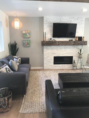 Een smart-tv, een open haard, boeken en een filmbibliotheek