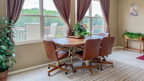 A dining area with a table, chairs, and a view of the outdoors. - Lake Taneycomo Waterfront Condo | Marina Access + 2 King Beds (AP79-1) (Branson)