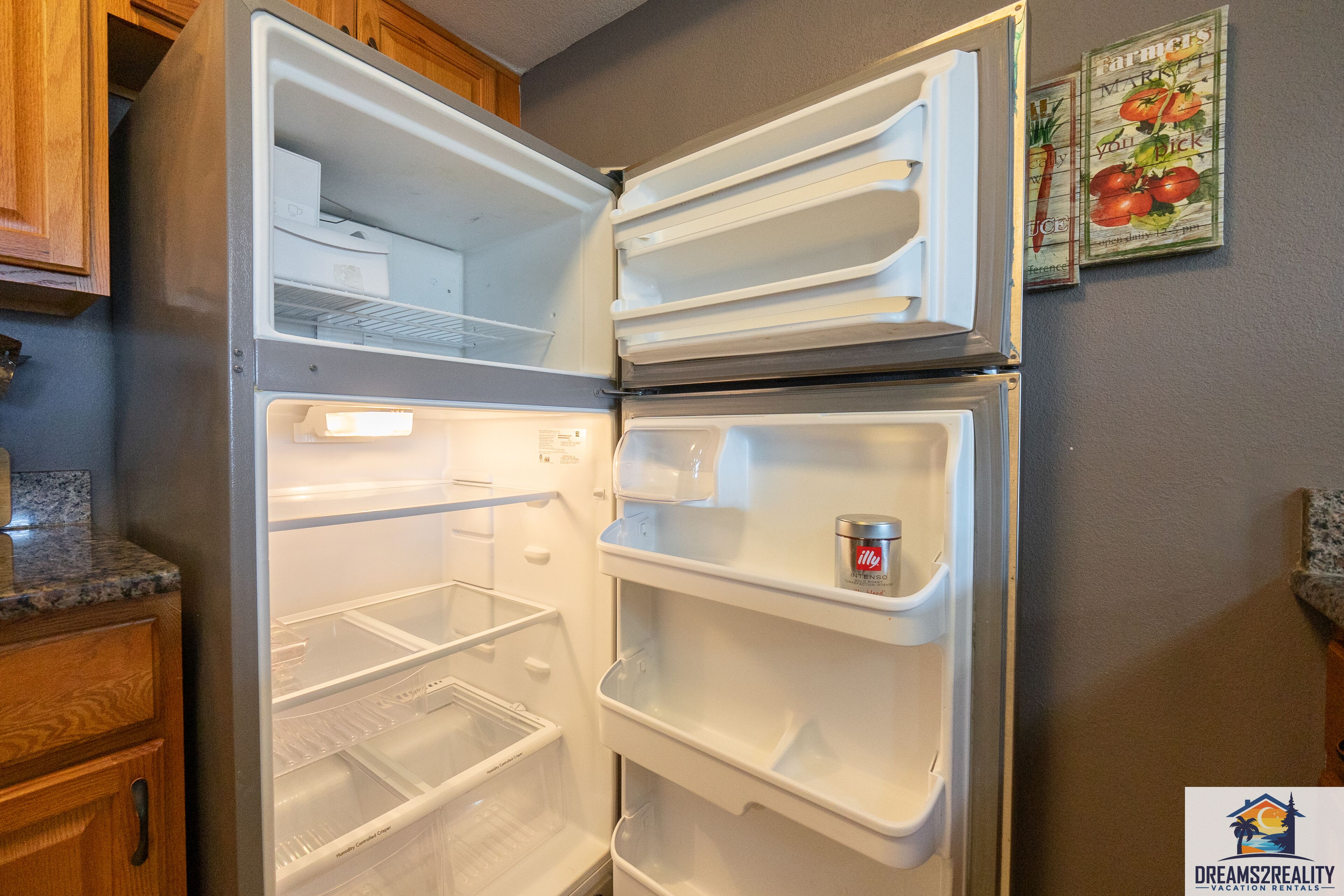 An open refrigerator with multiple shelves and a freezer compartment.