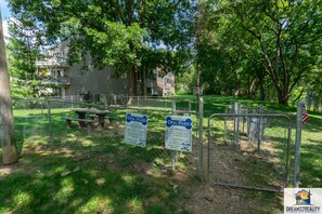Relax and unwind in our secure, fenced dog park with picnic tables and lush green surroundings.