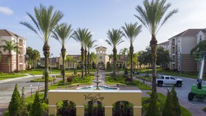 A resort with a central fountain, palm trees, and a sign reading "Vista Cay Resort". - Location,Location,Orlando3bdr 2bthl,Resort near all parks, Conv.Ctr, Int. Dr (Orlando)