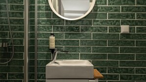 A bathroom with a shower, a sink, and a mirror. - Elegant Luxury Old Town Studio-apt by Lisbeyond (Lisboa)