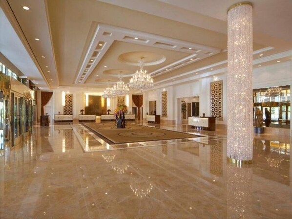 Experience the grandeur of our lobby, featuring a polished floor, a stunning chandelier, and elegant moldings.