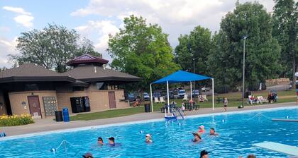 Spacious mobile home with large kitchen/living area and porch with barbeque.