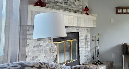 Spacious mobile home with large kitchen/living area and porch with barbeque.