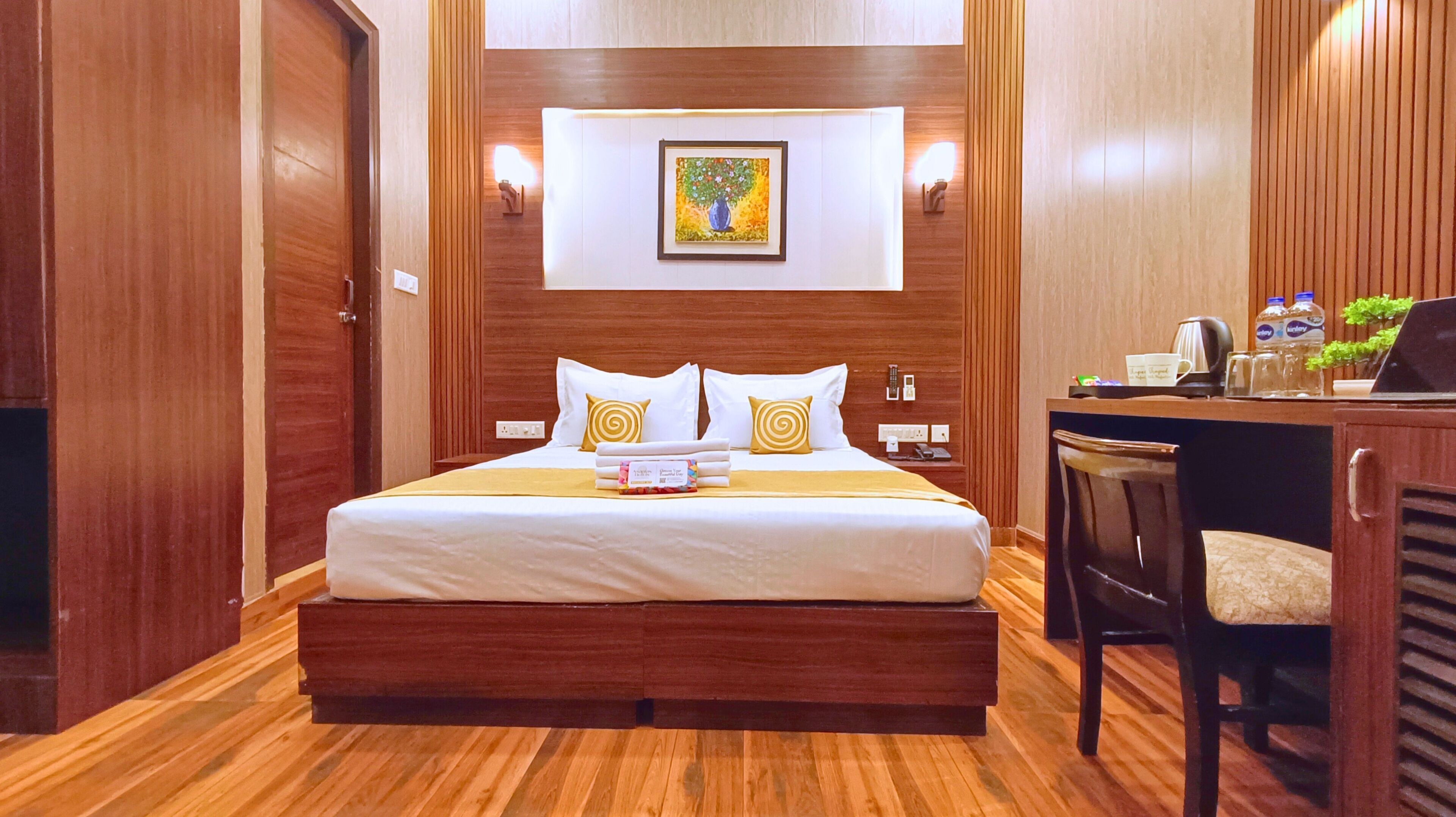 Een hotelkamer met een houten bed, een bureau en een stoel.