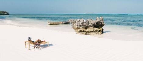 On the beach, white sand, sun-loungers, beach umbrellas