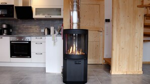 A modern kitchen with a wood-burning stove, built-in oven, and microwave. - Superior Chalet # 61 with IR-Sauna (Hohentauern)