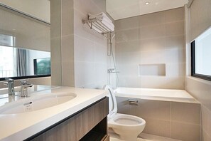 A modern bathroom with a dual sink vanity, a toilet, a shower, and a bathtub. - Hanoi Home 3 - Luxury Apartment (Hanoi)