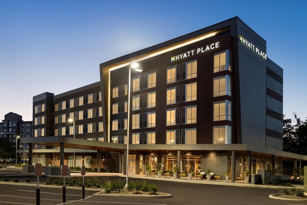 A modern hotel building with multiple floors, large windows, and a well-lit entrance area. - Hyatt Place Columbus/Polaris (Columbus)