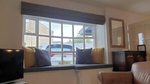 A living room with a large window, a television, a sofa, and a cabinet. - Bashall Barn, Eaves Hall, Outbarn all Close by (Clitheroe)