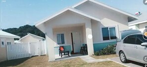 Guests can enjoy a quiet stay in this single-story home with a front porch and a grassy lawn.