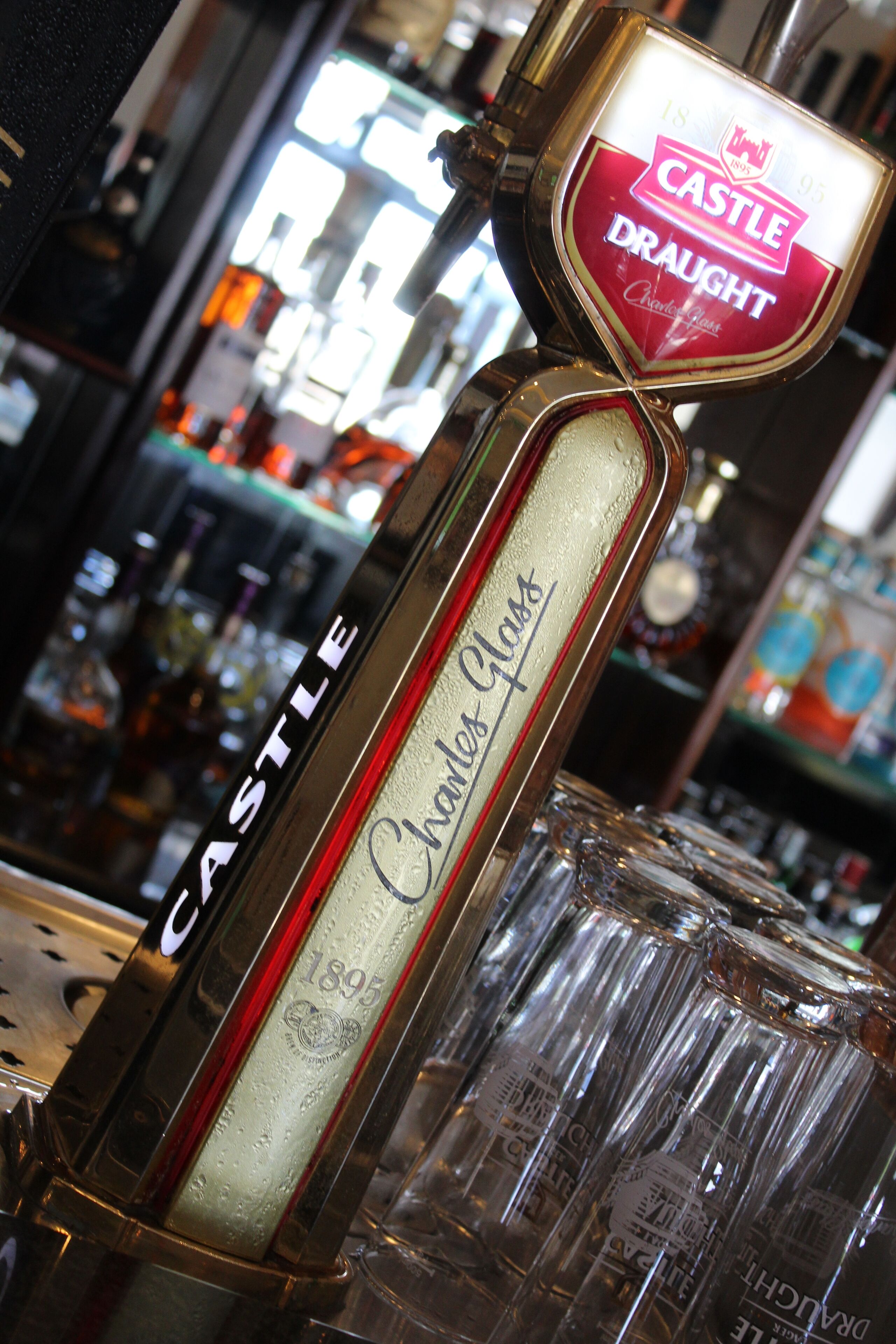 A bar tap labeled "Castle Draught" with a vintage design.