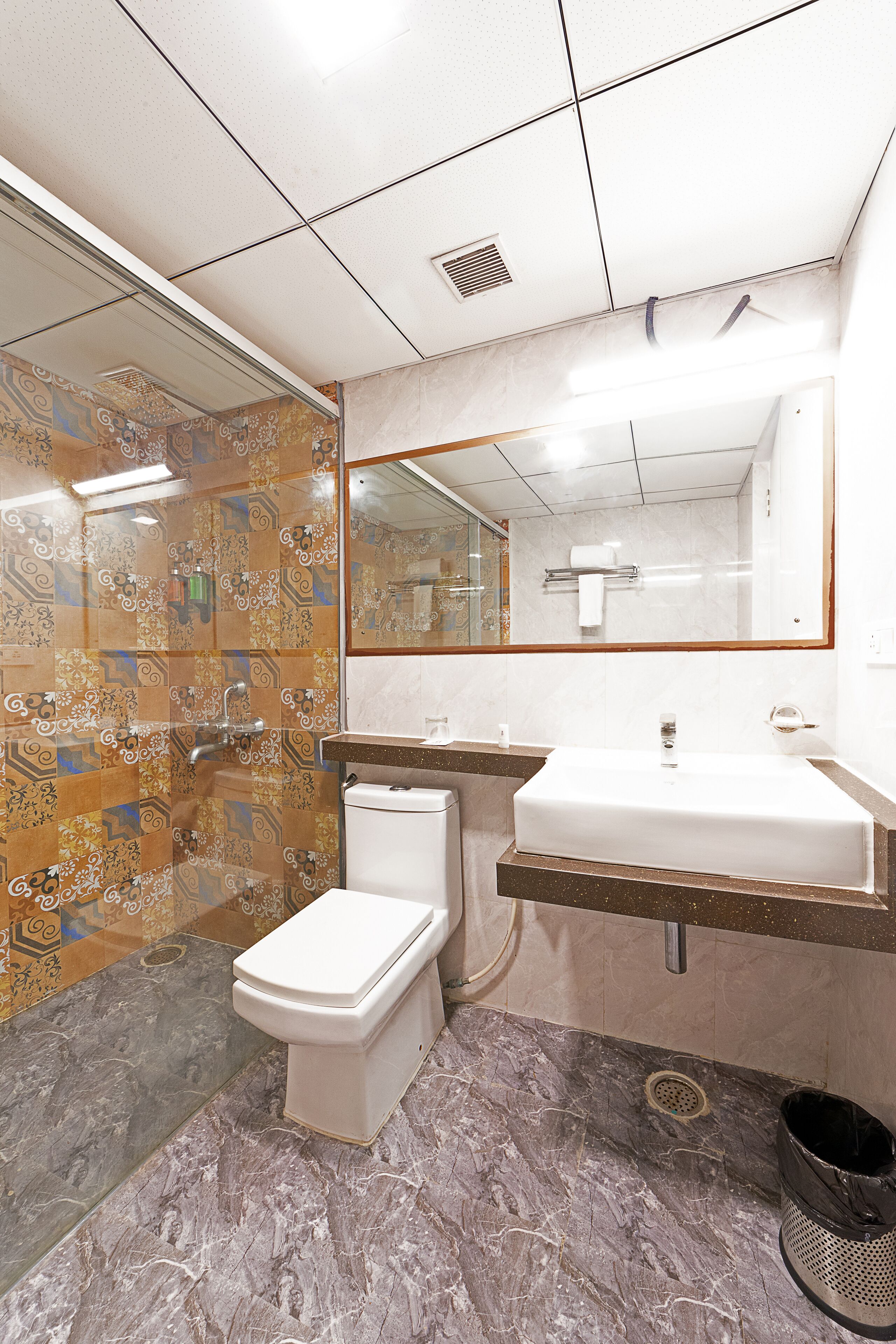 A bathroom with a toilet, sink, and shower.