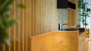 A modern kitchen with wooden paneling, a stainless steel sink, and built-in cabinets. - Best Western Parkhotel Hagenberg (Hagenberg im Mühlkreis)