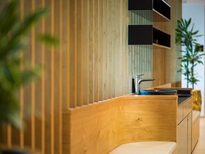 A modern kitchen with wooden paneling, a stainless steel sink, and built-in cabinets. - Best Western Parkhotel Hagenberg (Hagenberg im Mühlkreis)
