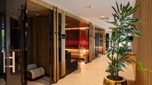 A modern hotel lobby with wooden paneling, glass doors, and a potted plant. - Best Western Parkhotel Hagenberg (Hagenberg im Mühlkreis)