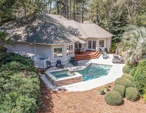 A house with a swimming pool, patio furniture, and a covered outdoor area. - Something for everyone- private pool on the water and pool table! (Hilton Head)