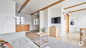 A modern apartment with a living room, kitchen, and dining area.