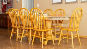 A dining area with a round table surrounded by wooden chairs with curved backs. - Vacation Home w/red rock views, Near Zion & Bryce (Kanab)