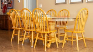 A dining area with a round table surrounded by wooden chairs with curved backs. - Vacation Home w/red rock views, Near Zion & Bryce (Kanab)