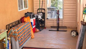 A compact room with a bed, a small table, and a chair. There is a cooler, a mop, and a soccer ball on the floor. - Vacation Home w/red rock views, Near Zion & Bryce (Kanab)