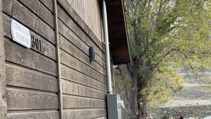 A wooden building with a sign reading "Corral Villas Yellowstone 301". - CORRAL VILLAS<br>Deluxe studios in the north entrance to Yellowstone (Gardiner)