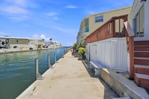 A waterfront property with a dock, a marina, and a row of houses. - Oceanview Paradise AT Venture Out+4 Bikes & 2-2 Seat Kayaks! King & Queen Beds! (Cudjoe Key)