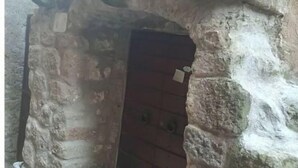A stone archway leading to a dark interior space, possibly a doorway or entrance. - La Casetta in the historic center of Bomarzo (Bomarzo)