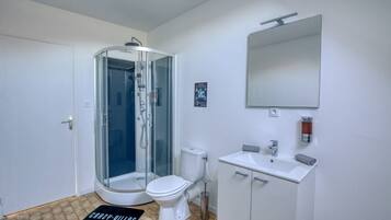 Bathtub, hair dryer, shampoo, toilet paper