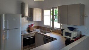 A modern kitchen with a refrigerator, stove, sink, and microwave. - Independent apartment, - 4 people (Reillanne)