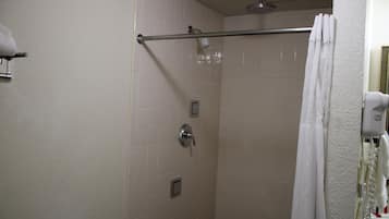 A shower with a glass door, a towel rack, and a showerhead.