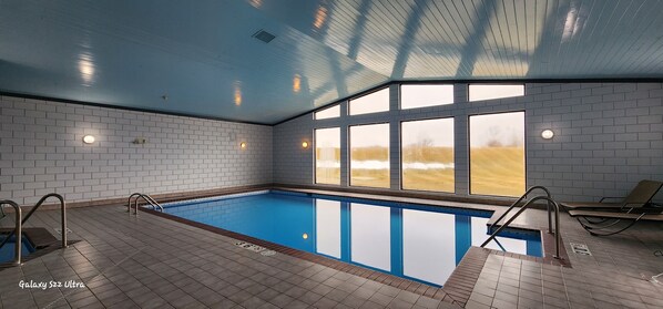 Indoor pool, open 6:00 AM to 10:00 PM, pool loungers