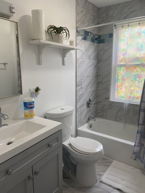 Bathtub, hair dryer, towels, soap