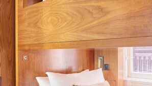 A bunk bed with wooden headboard and white bedding. - FOUND Hotel, San Francisco (San Francisco)