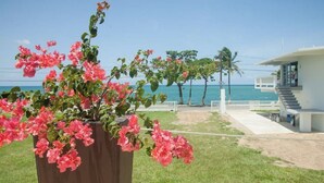 A modern house with a concrete staircase leading to a balcony overlooking the ocean. - LaCasita Ocean Front House (Aguada)