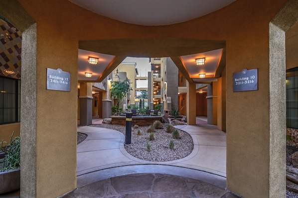 A hotel atrium with a central courtyard, multiple floors, and signage for Building 10 and Building 12.