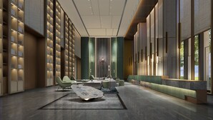 A modern hotel lobby with a long reception desk, seating area, and a unique ceiling design. - Somerset Daxing Beijing (Daxing)
