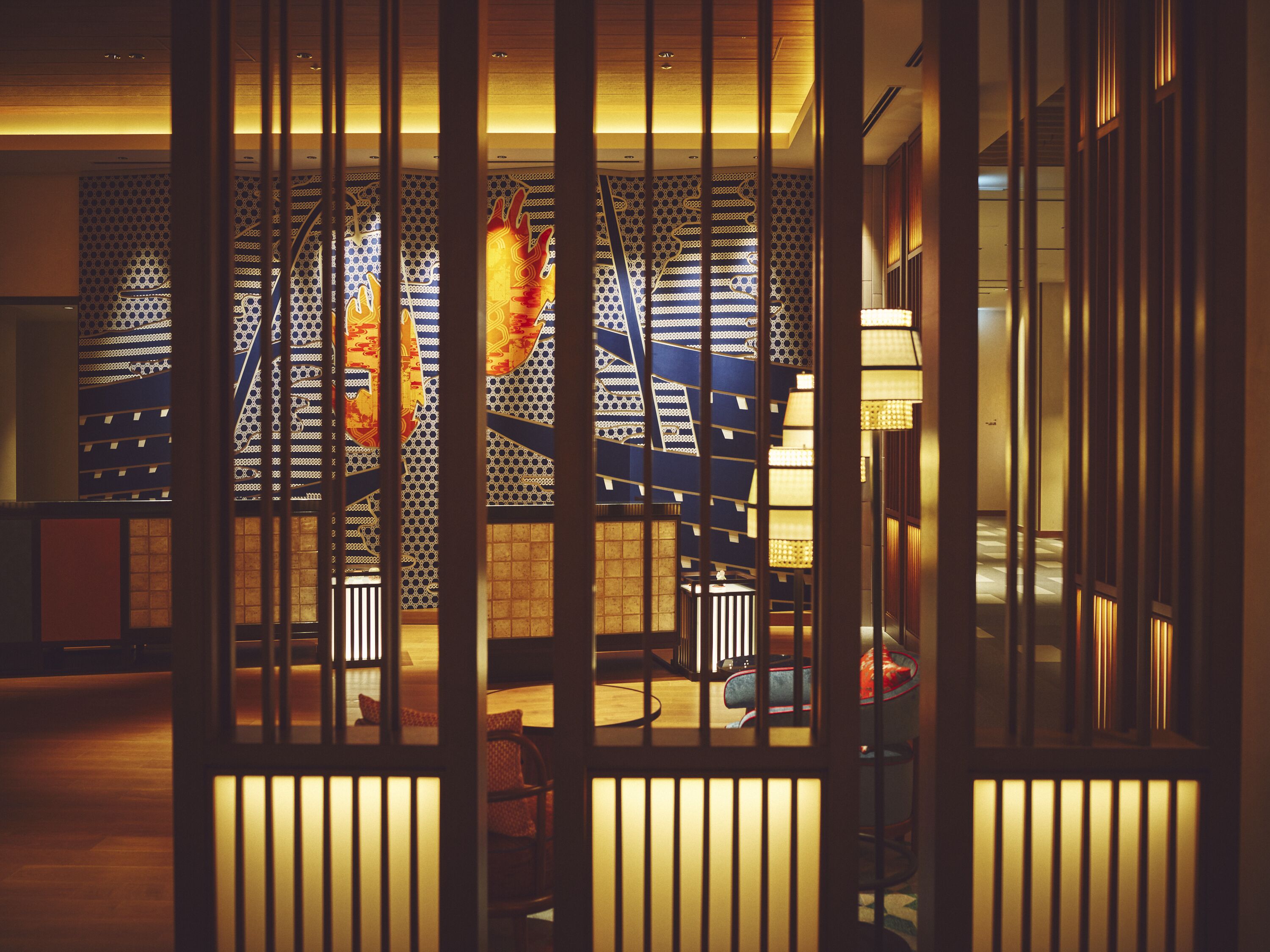 A room with a traditional Japanese-style sliding door, a patterned wall, and a wooden floor.