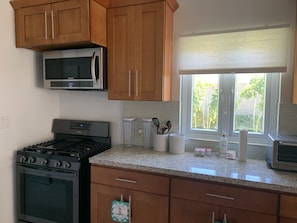 Enjoy cooking in this well-equipped kitchen with a gas stove, microwave, and ample storage.