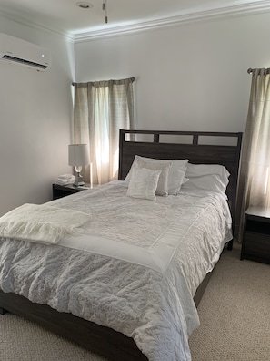 Cozy retreat with a large bed, two nightstands, and a dark headboard.