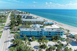 A coastal hotel with multiple buildings, a beach, and a road. - 3 Bedroom-Beachfront Condo with Most Amazing Sunset Views of the Gulf (Englewood)