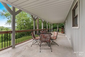 Relax in this serene outdoor space with a seating area, complete with tables and comfortable chairs.
