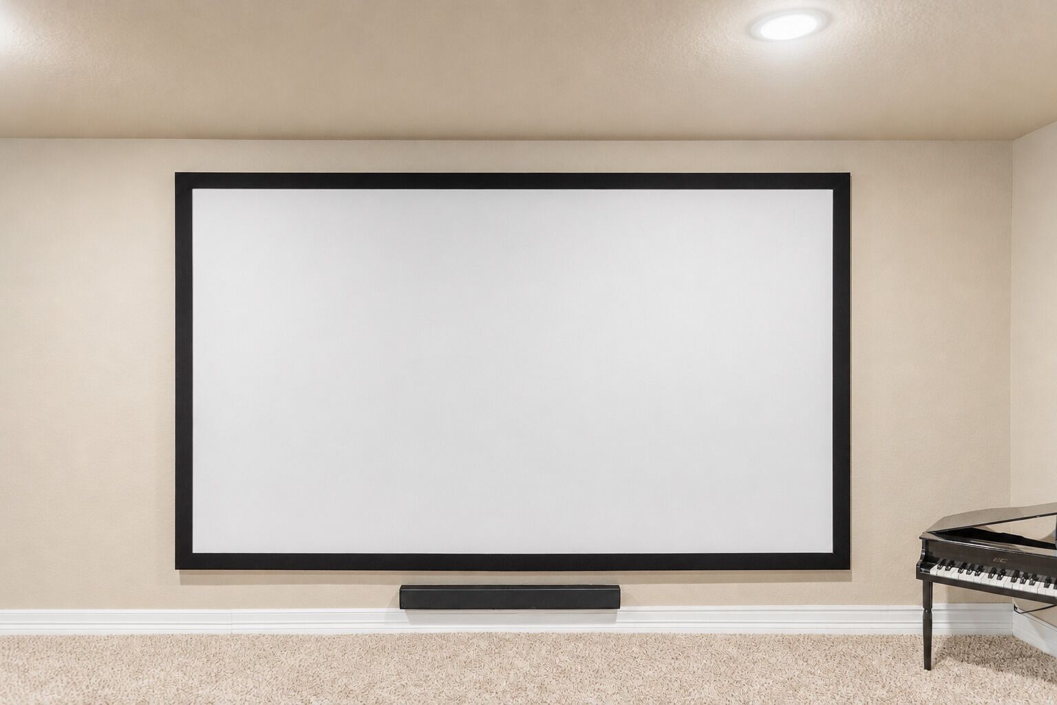 A blank projection screen mounted on a wall with a piano to the right.