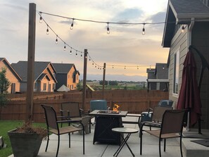 Relax by the fire pit surrounded by comfortable chairs in a peaceful outdoor setting.