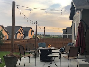 Relax by the fire pit surrounded by comfortable chairs in a peaceful outdoor setting.
