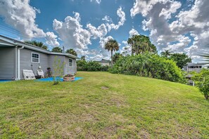 A residential backyard with a swimming pool, a lawn, and a house. - 2 Mi to Beach: Canal-Front Home in Hudson! (Hudson)